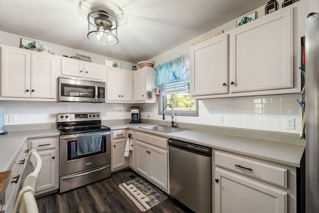 kitchen featuring white cabinets, appliances with stainless steel finishes, and sink