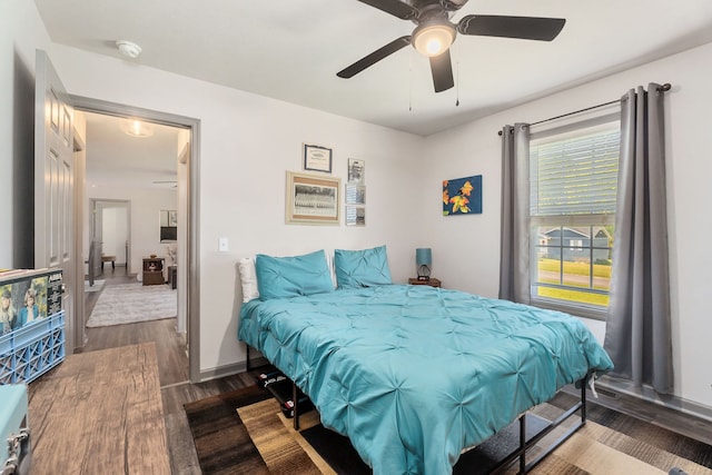 bedroom with ceiling fan and dark wood-type flooring