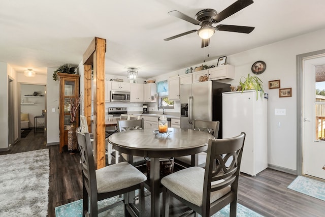 dining space featuring ceiling fan and dark hardwood / wood-style floors