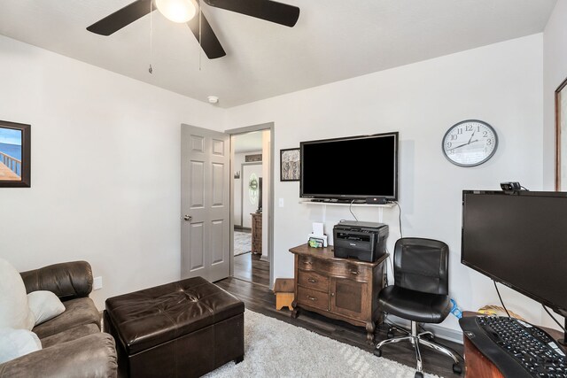 home office with ceiling fan and dark wood-type flooring