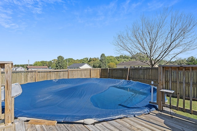 view of swimming pool with a wooden deck