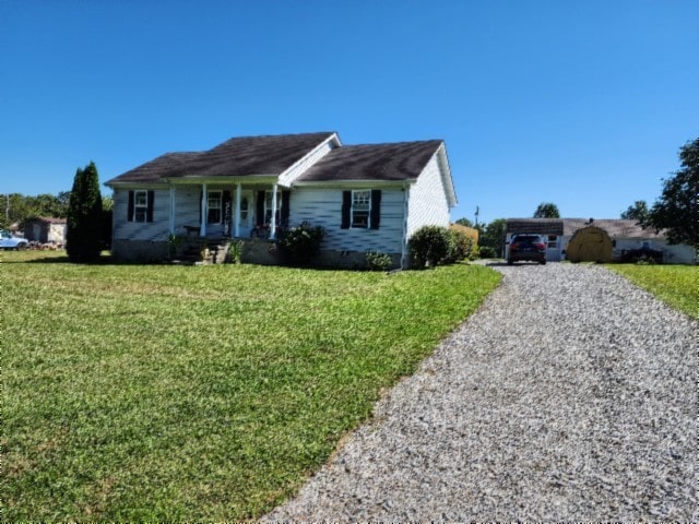 view of front of property with a front lawn and a carport