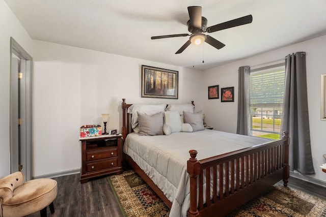 bedroom with ceiling fan and dark hardwood / wood-style floors