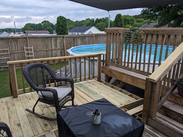 deck with a fenced in pool