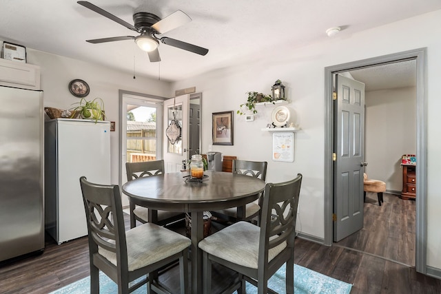 dining space with ceiling fan and dark hardwood / wood-style floors