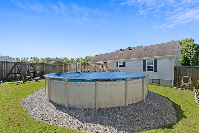 view of swimming pool with a yard