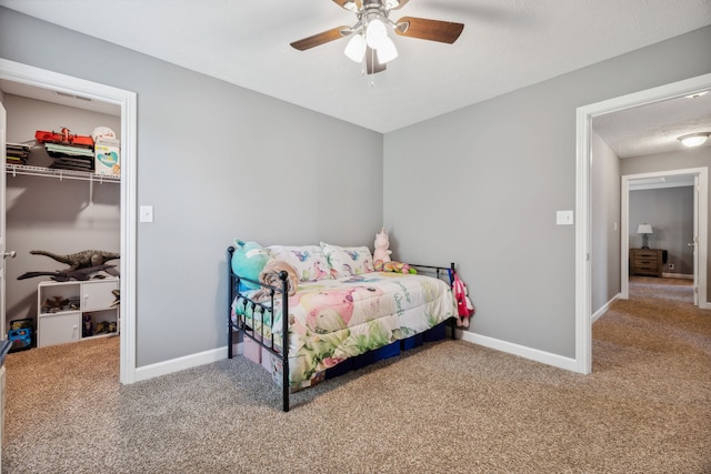 carpeted bedroom featuring a closet, a textured ceiling, and ceiling fan