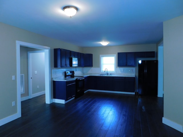 kitchen featuring black appliances, decorative backsplash, sink, and dark hardwood / wood-style flooring