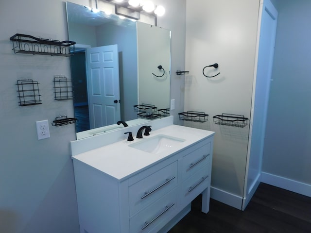 bathroom featuring hardwood / wood-style flooring and vanity