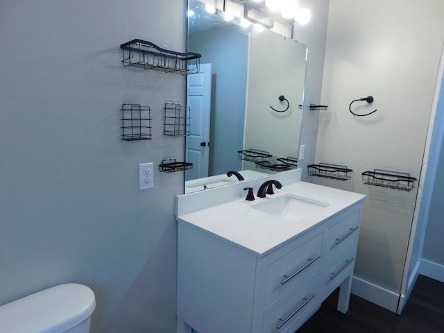 bathroom featuring hardwood / wood-style flooring, vanity, and toilet