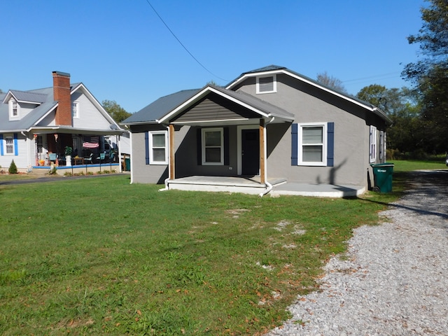 rear view of property featuring a lawn