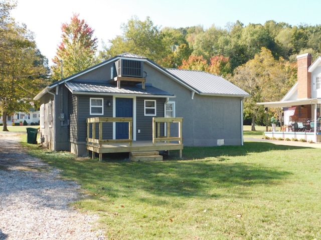 rear view of house with a yard