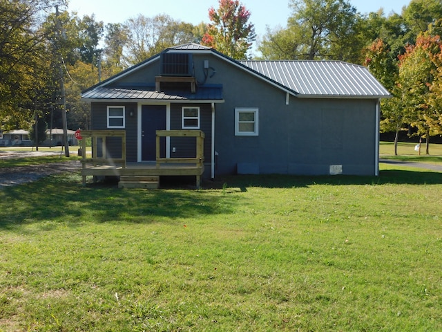 rear view of house featuring a yard and a wooden deck