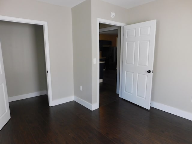 unfurnished bedroom with dark hardwood / wood-style floors