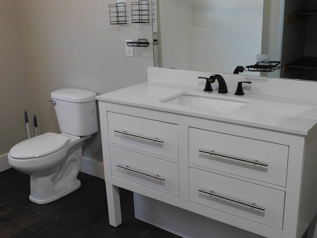 bathroom featuring hardwood / wood-style floors, vanity, and toilet