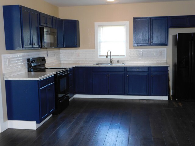 kitchen with sink, black appliances, blue cabinetry, dark hardwood / wood-style flooring, and decorative backsplash