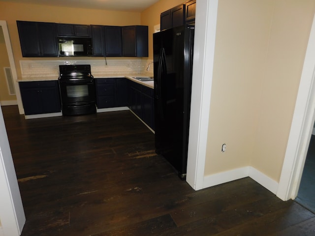 kitchen with sink, backsplash, dark hardwood / wood-style flooring, and black appliances