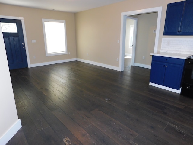 unfurnished living room with dark hardwood / wood-style flooring