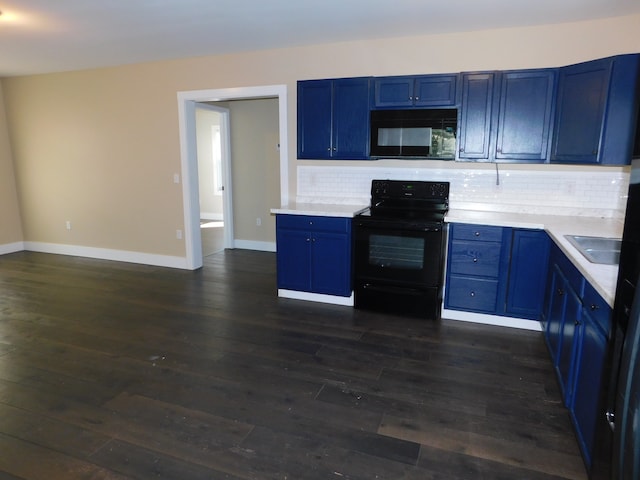 kitchen with dark hardwood / wood-style floors, blue cabinetry, black appliances, and backsplash