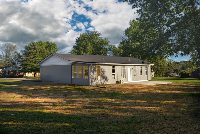 rear view of property with a yard