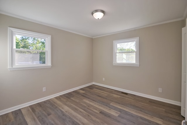 spare room featuring dark wood-type flooring and ornamental molding