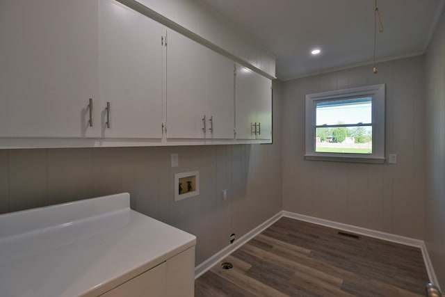 laundry room featuring cabinets, dark hardwood / wood-style floors, crown molding, and hookup for a washing machine