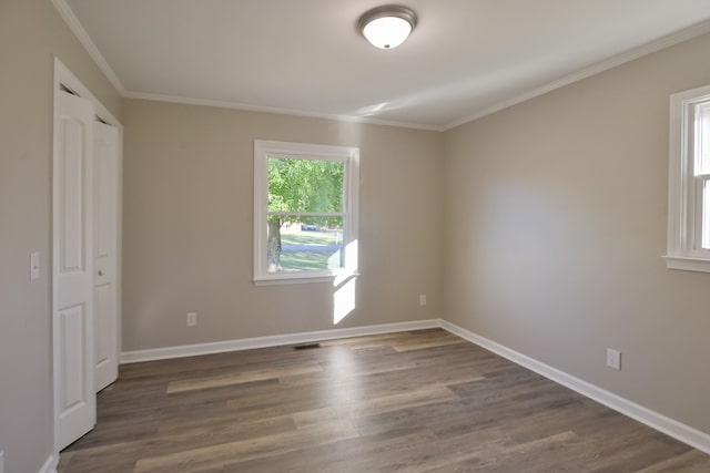 unfurnished bedroom with dark hardwood / wood-style floors and ornamental molding