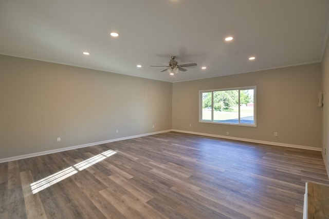 unfurnished room with ceiling fan and dark hardwood / wood-style floors