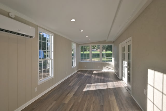 unfurnished sunroom featuring an AC wall unit and vaulted ceiling