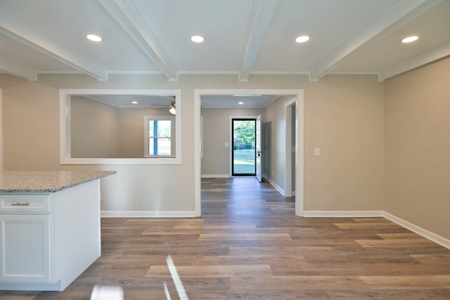 interior space featuring light hardwood / wood-style floors, ceiling fan, light stone countertops, white cabinets, and beamed ceiling