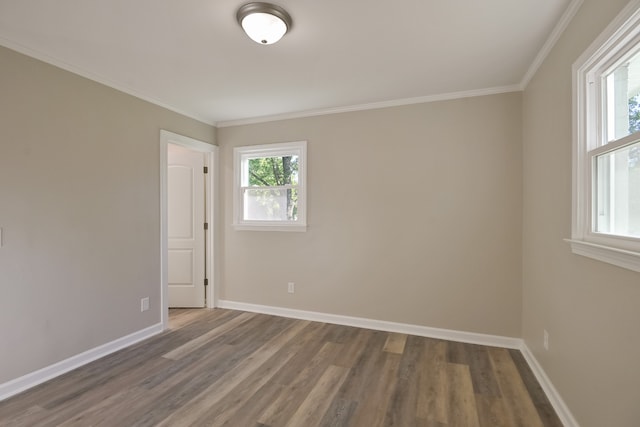 unfurnished room featuring dark wood-type flooring and ornamental molding