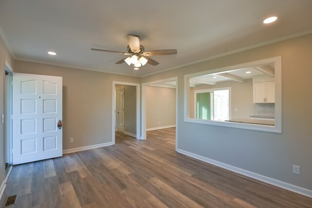 unfurnished room with ceiling fan, dark hardwood / wood-style flooring, and crown molding