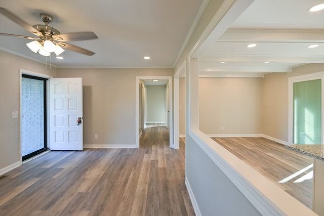 hall with ornamental molding and wood-type flooring