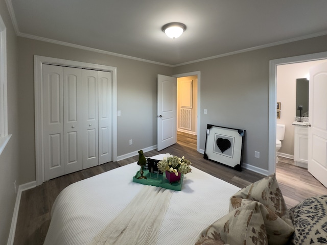 bedroom featuring a closet, ornamental molding, dark hardwood / wood-style floors, and ensuite bath