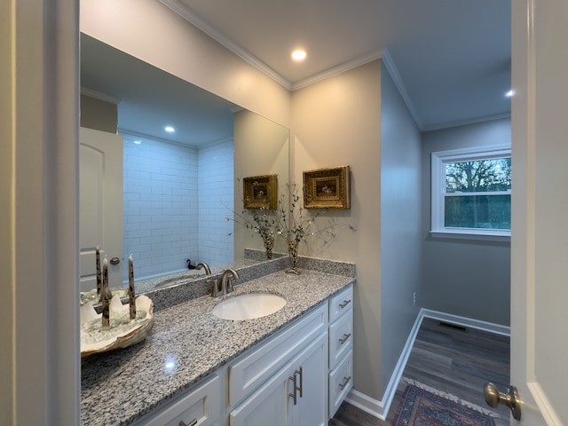 bathroom featuring vanity, wood-type flooring, and ornamental molding