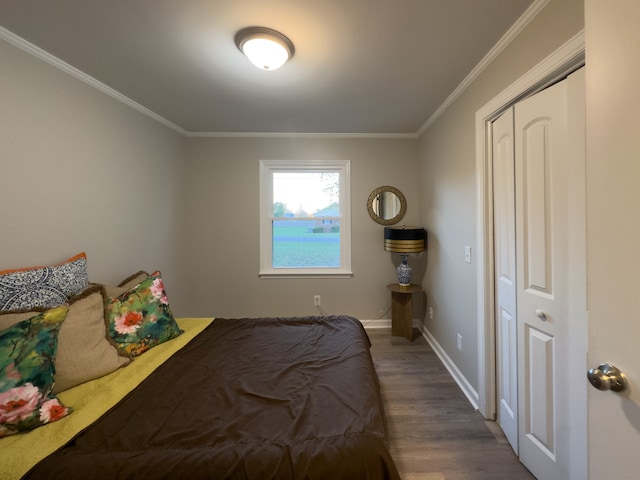 bedroom with a closet, ornamental molding, and wood-type flooring