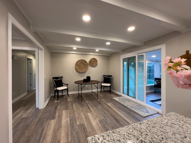 sitting room with dark hardwood / wood-style flooring and beamed ceiling