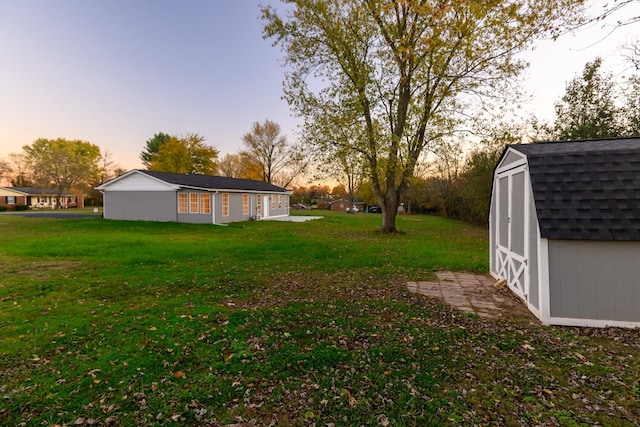 yard at dusk with a storage unit