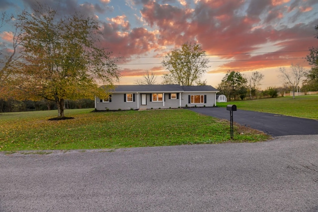 ranch-style home featuring a yard