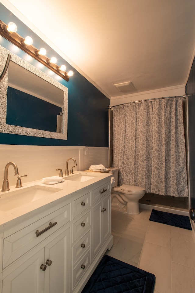 bathroom with vanity, tile patterned flooring, a shower with curtain, crown molding, and toilet