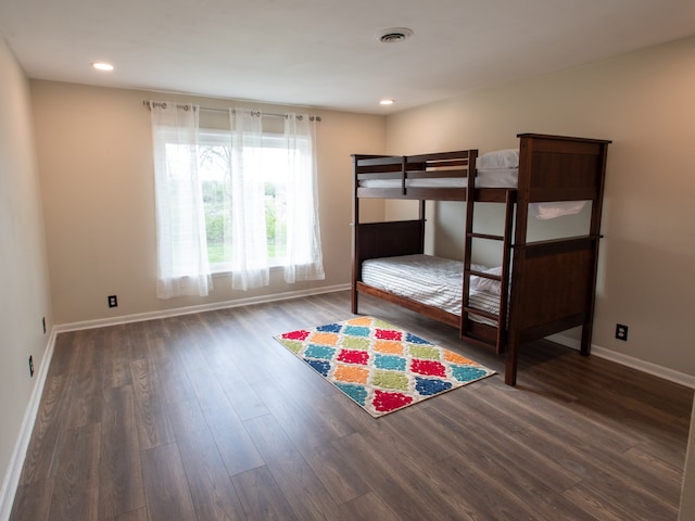 unfurnished bedroom with dark wood-type flooring