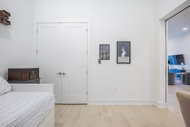 bedroom featuring a closet and light hardwood / wood-style flooring