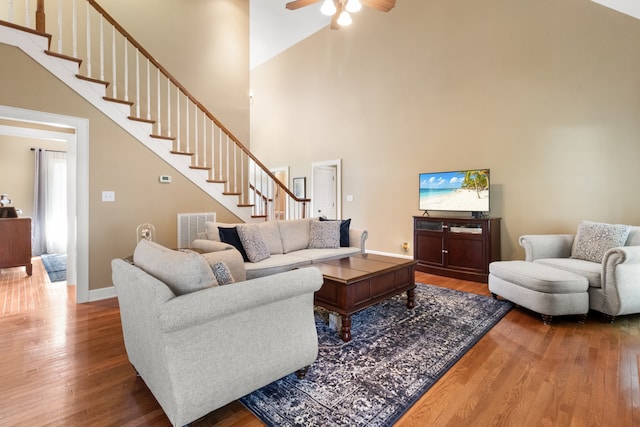 living room featuring high vaulted ceiling, hardwood / wood-style floors, and ceiling fan