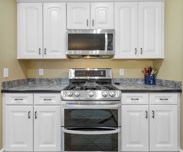 kitchen with stainless steel appliances and white cabinets