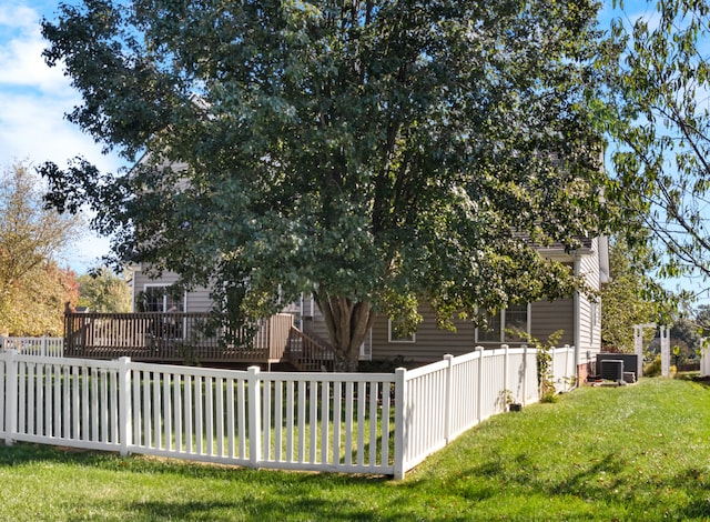 view of property exterior with a yard and central air condition unit