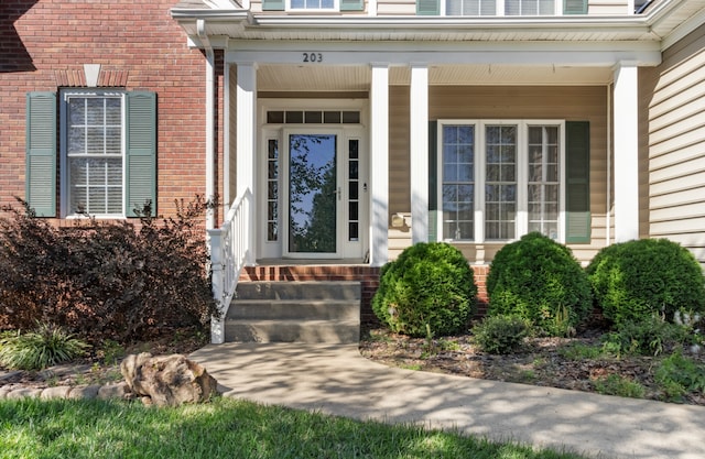 doorway to property featuring covered porch