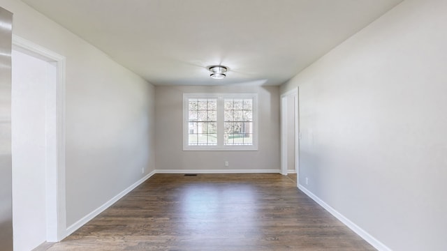 spare room featuring dark hardwood / wood-style floors