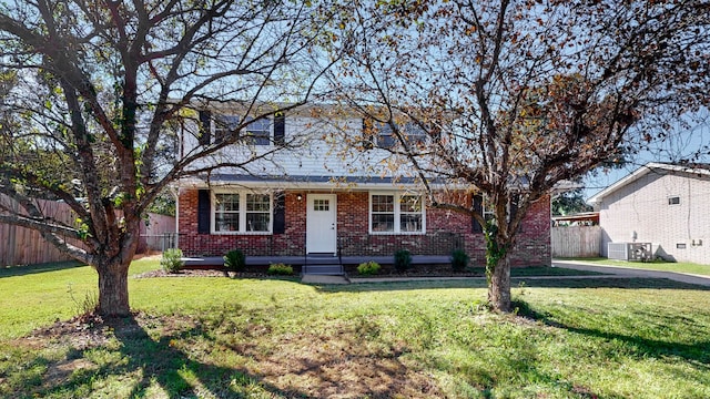 view of front of home featuring a front yard and cooling unit