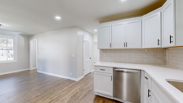 kitchen featuring dishwasher, hardwood / wood-style floors, and white cabinets