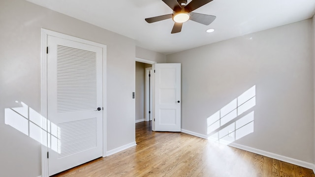 unfurnished bedroom featuring a closet, ceiling fan, and light hardwood / wood-style flooring